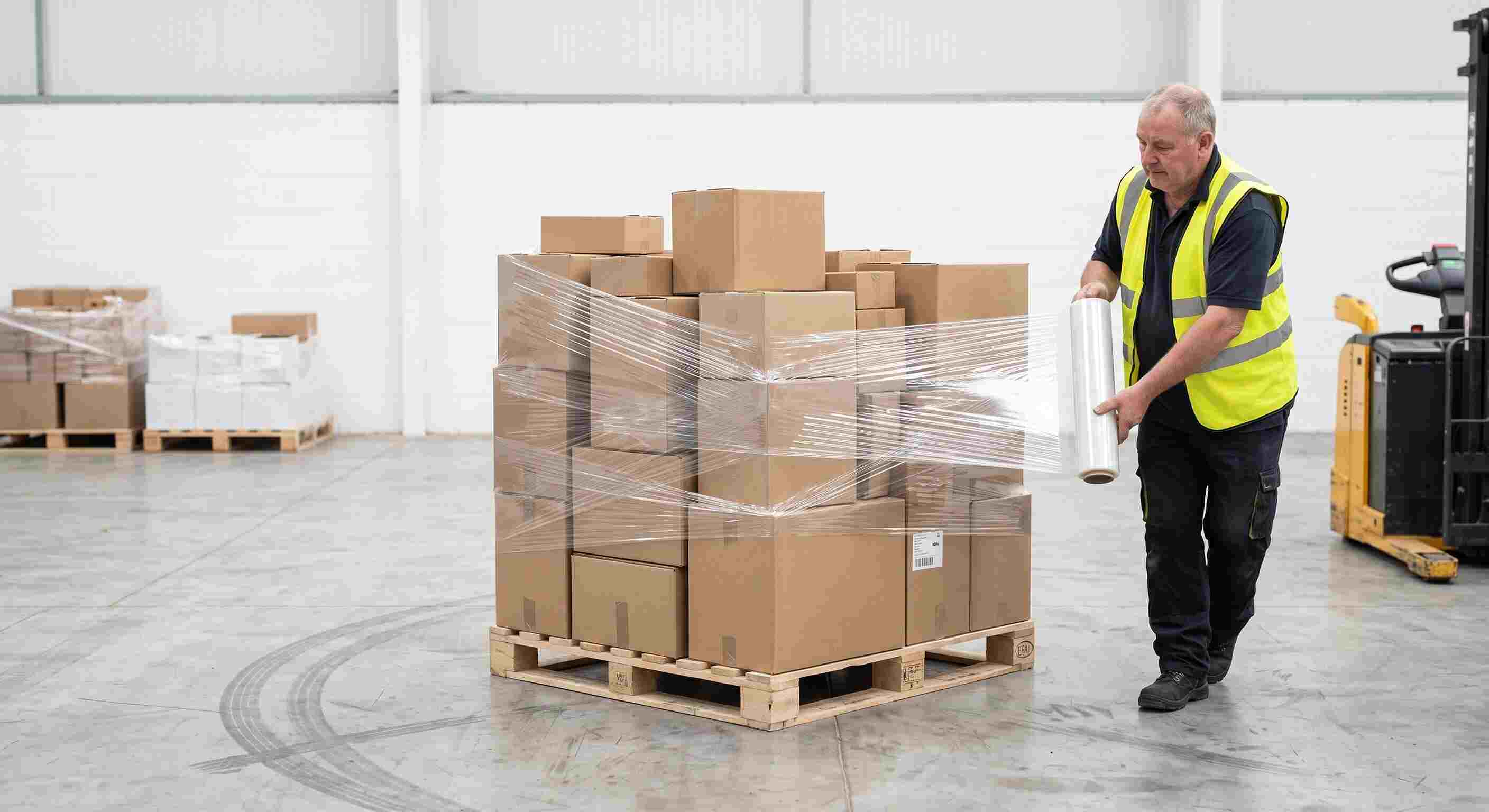 Warehouse workers handling logistics boxes